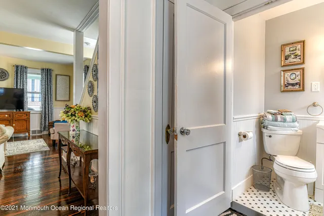 a bathroom with a toilet a sink and a mirror
