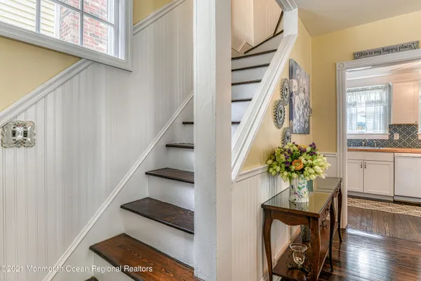a view of staircase with wooden floor and a potted plant