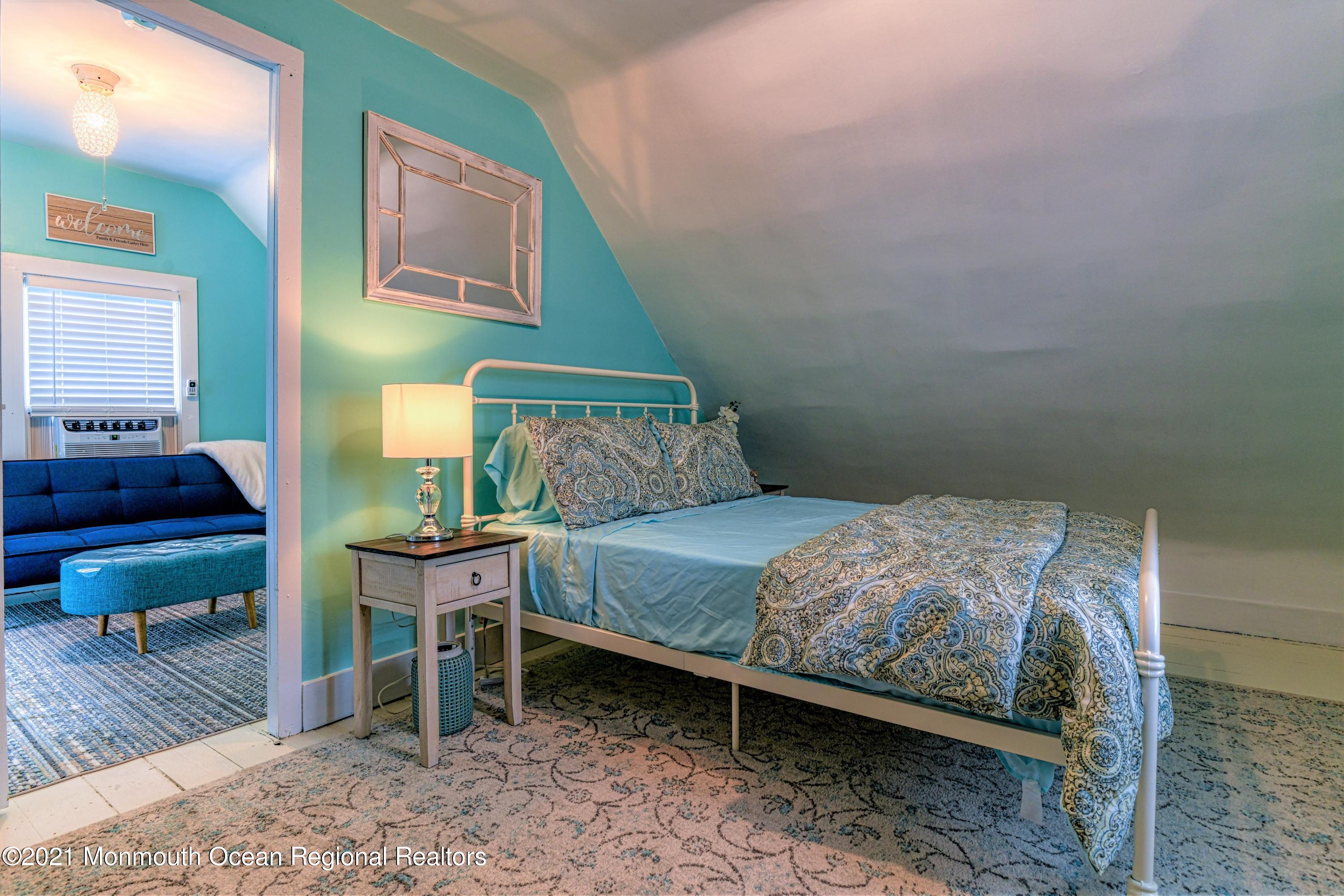 87 Embury Avenue Ocean Grove, NJ 07756 - Photo 29 of 55 a bedroom with a bed and a table in it