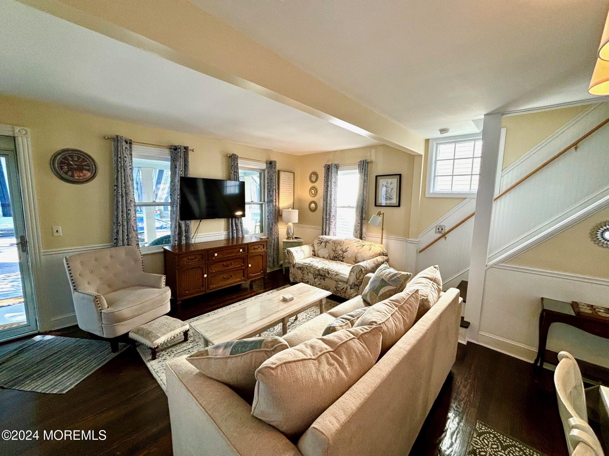 87 Embury Avenue Ocean Grove, NJ 07756 - Photo 9 of 55 a living room with furniture and a flat screen tv