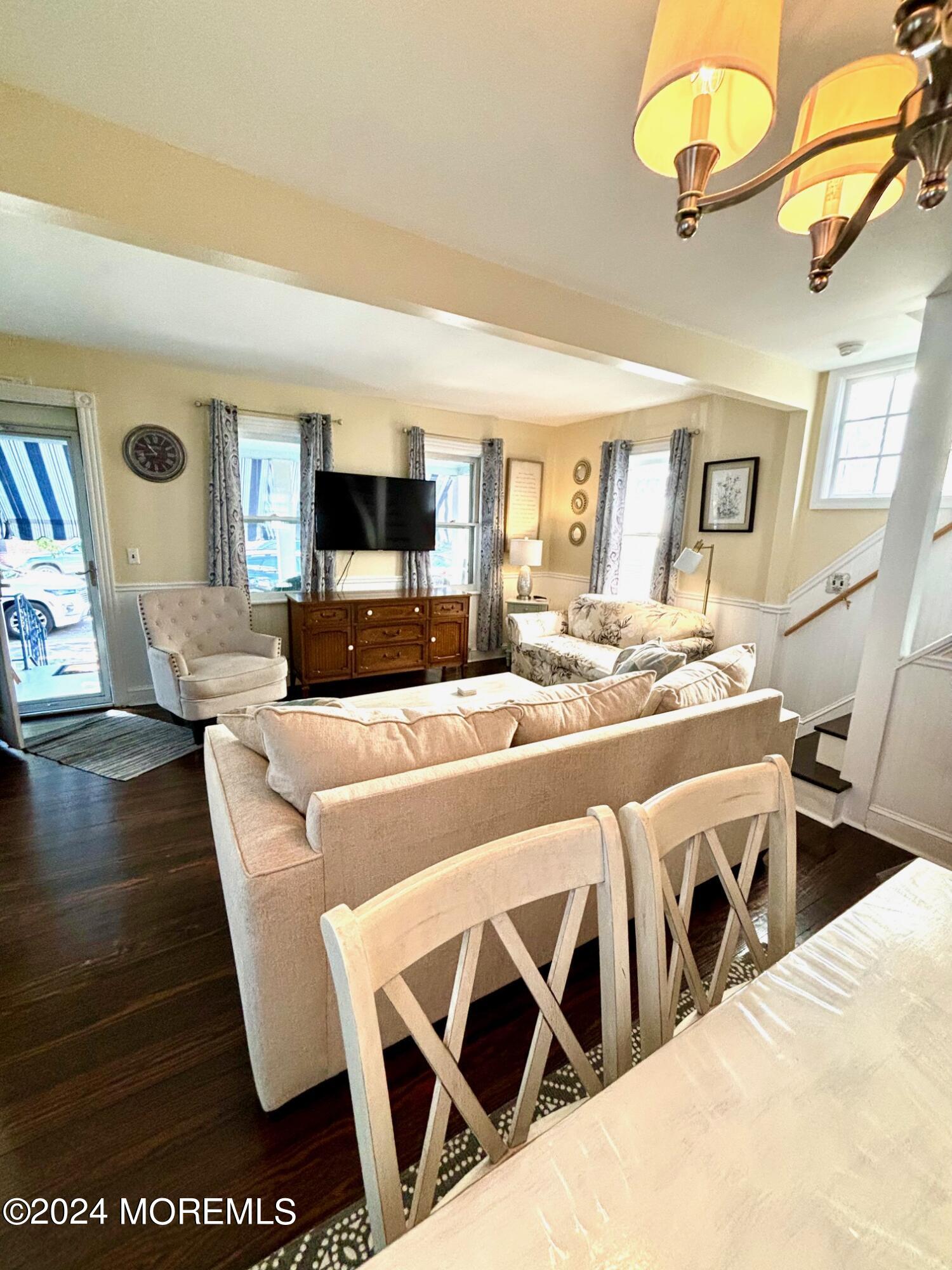 87 Embury Avenue Ocean Grove, NJ 07756 - Photo 10 of 55 a living room with furniture a flat screen tv and kitchen view