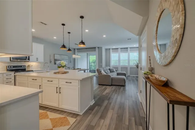 a kitchen with kitchen island granite countertop a sink counter top space and stainless steel appliances