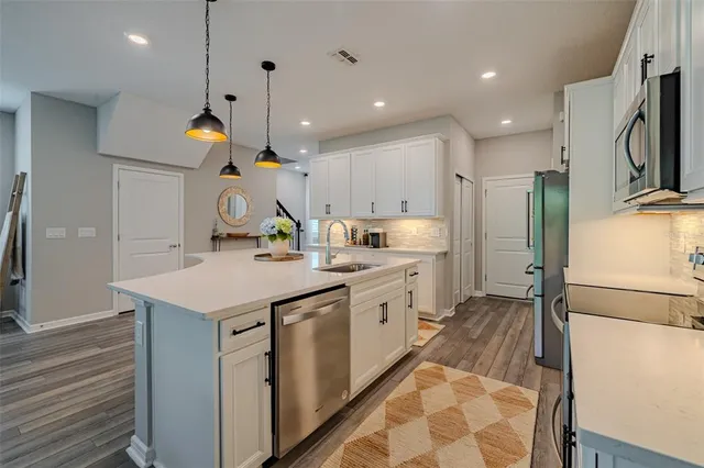 a kitchen with a sink a refrigerator and a stove