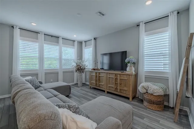 a bedroom with furniture and a flat screen tv