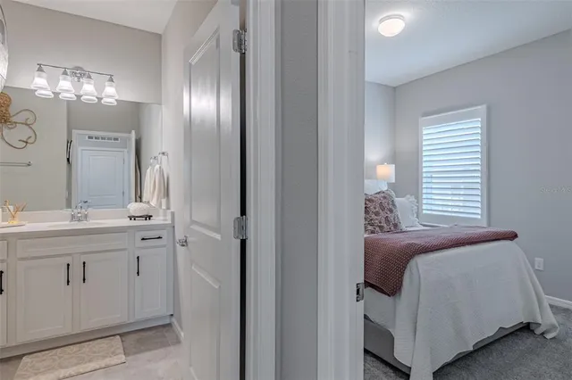 a spacious bathroom with a double vanity sink and a mirror