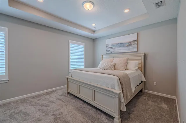 a spacious bedroom with a bed and window