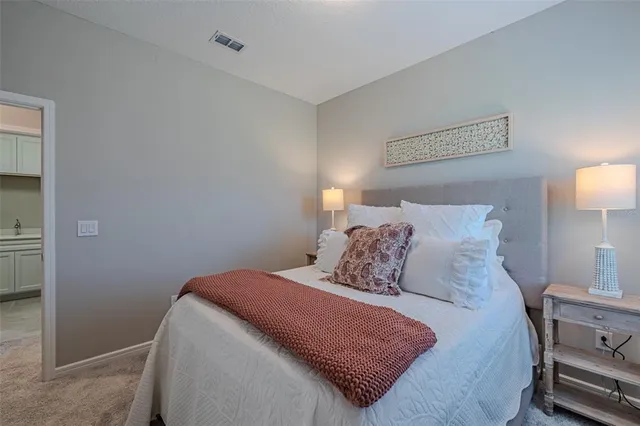 a bedroom with a bed and a lamp