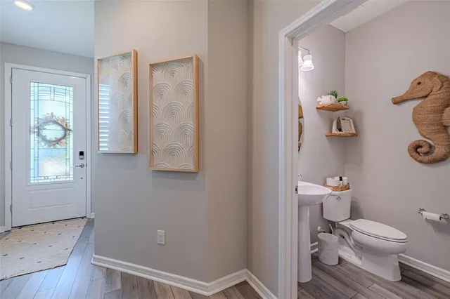 a bathroom with a toilet and a shower curtain