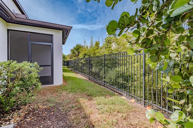 a view of yellow house with a flower garden