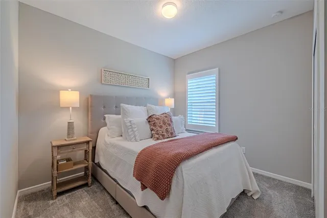 a bedroom with a bed and a lamp