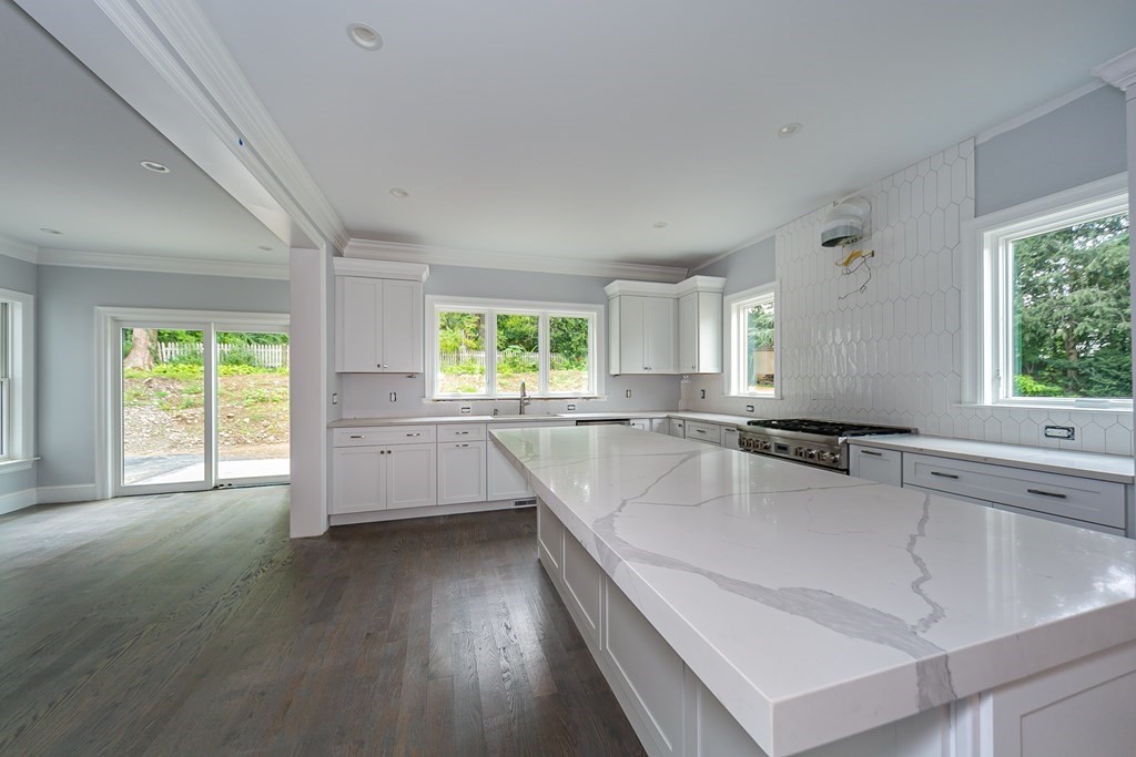 71 Elder Road Needham, MA 02494 - Photo 7 of 24 a large white kitchen with a large window sink and cabinets
