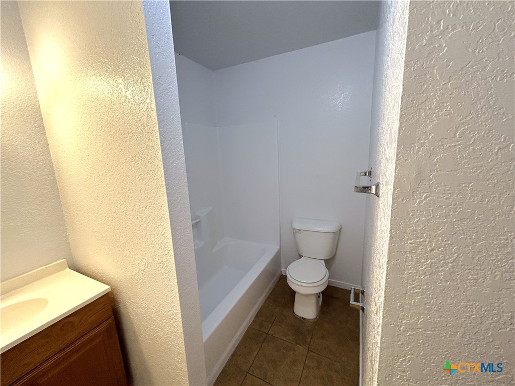 10411 Chaparral Road Killeen, TX 76548 - Photo 8 of 13 a bathroom with a toilet and a shower