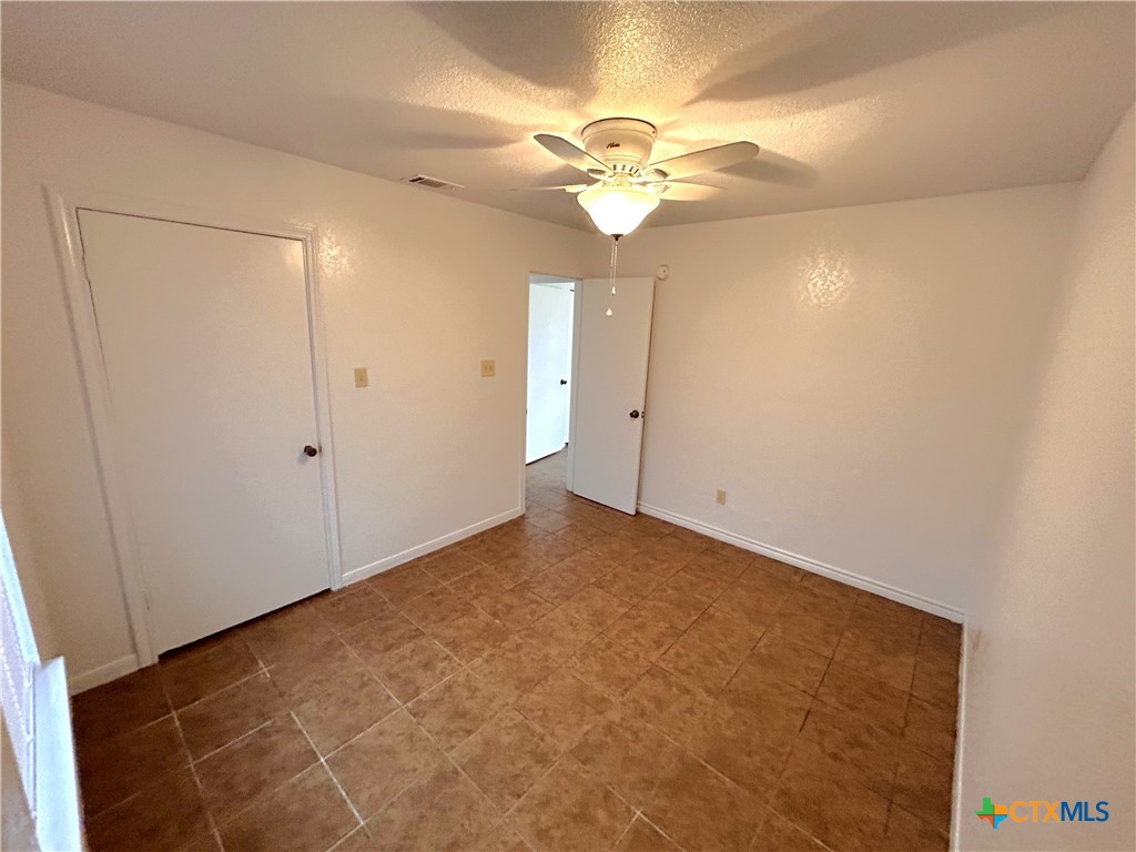 10411 Chaparral Road Killeen, TX 76548 - Photo 10 of 13 a view of an empty room with a chandelier fan