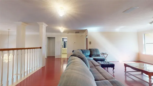 a view of staircase with wooden floor and white walls