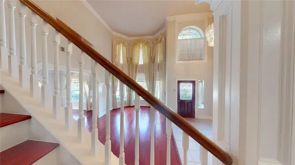 a bedroom with a bed and a large mirror on the dresser