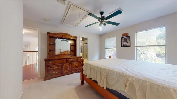 a bedroom with a bed mirror and window