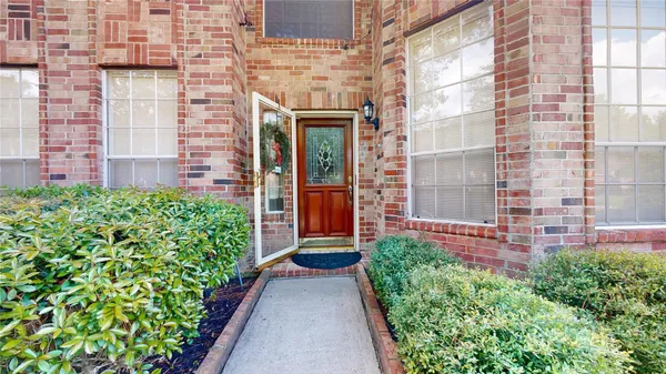 an entrance to house with yard and green space