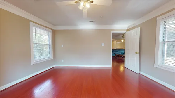a view of empty room with wooden floor