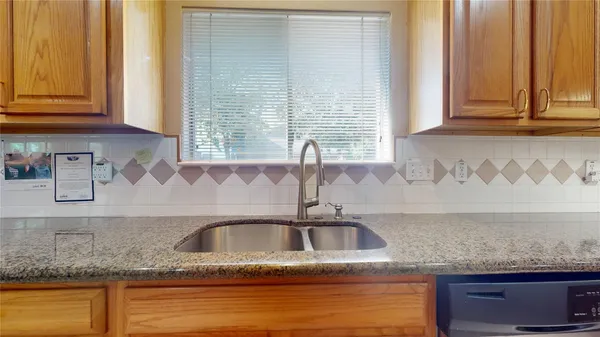 a kitchen with granite countertop a sink and a window