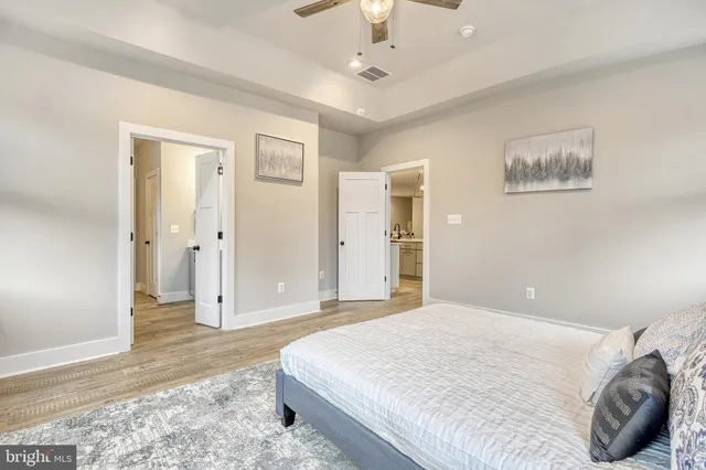 a spacious bedroom with a bed and a window