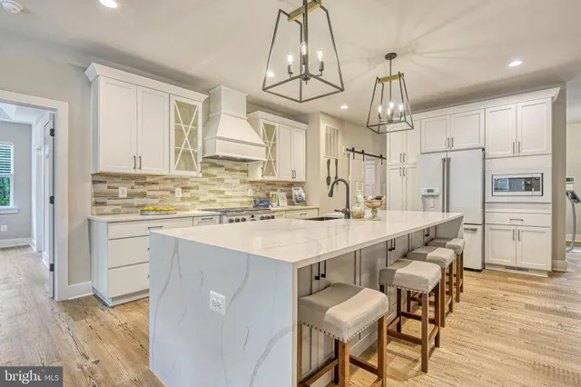 a kitchen with stainless steel appliances kitchen island granite countertop a sink and cabinets