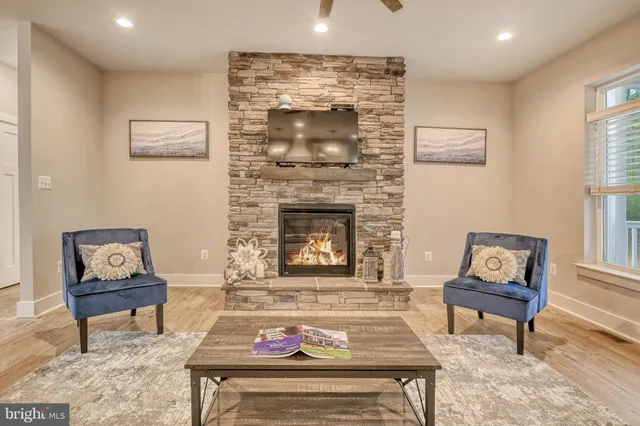 a living room with furniture and a fireplace