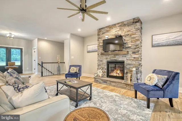 a living room with furniture and a fireplace