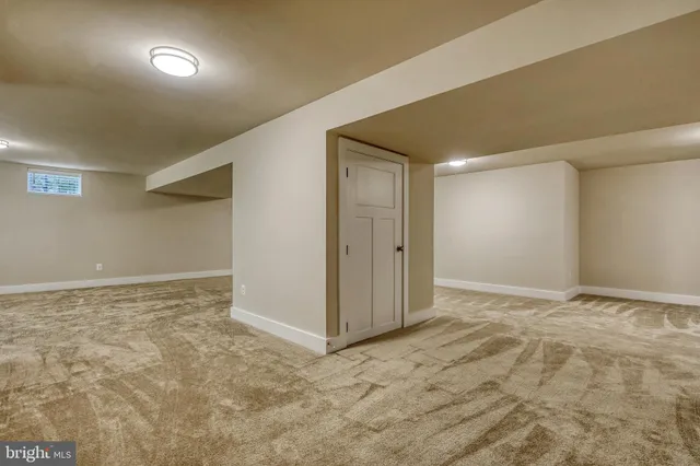 a view of an empty room and kitchen