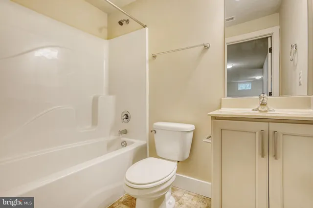 a view of empty room with a fireplace