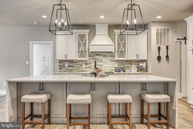 a kitchen with stainless steel appliances a table and chairs in it