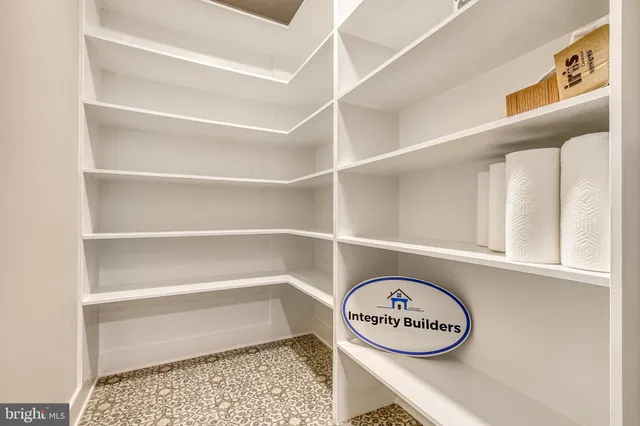 a view of a room with shelves and a table