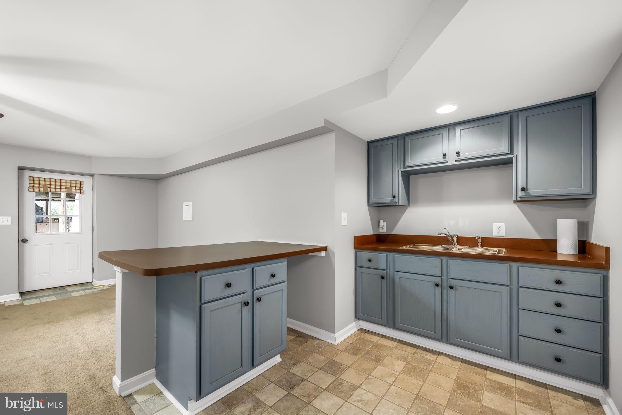 6657 Lawyers Road Spotsylvania, VA 22551 - Photo 41 of 73 a kitchen with granite countertop a sink and cabinets