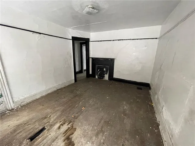 a view of an empty room with a fireplace