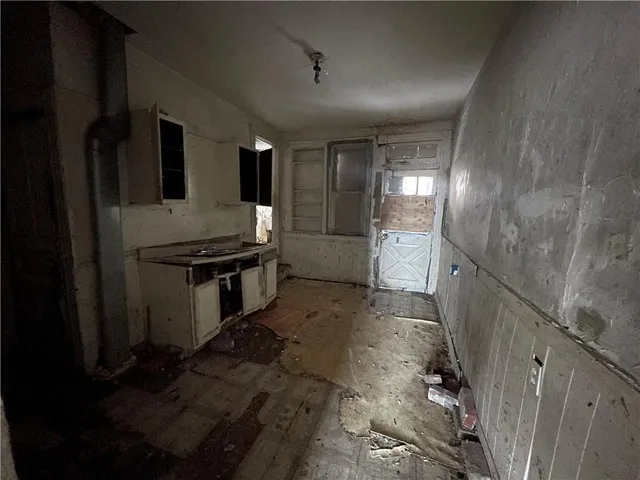a view of a refrigerator in kitchen and wooden floor