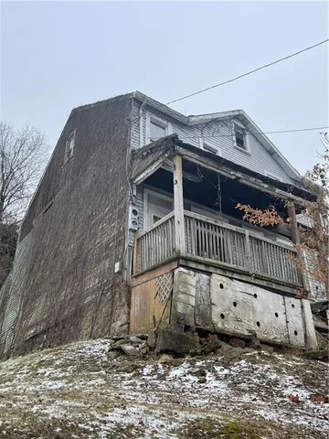 a view of a house with a wooden fence
