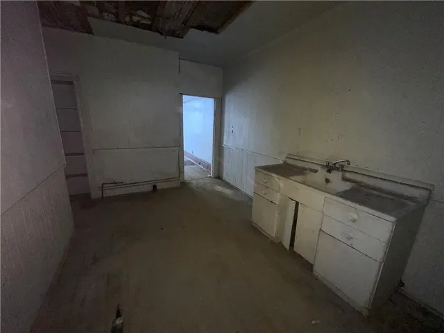 a utility room with a sink washer and dryer