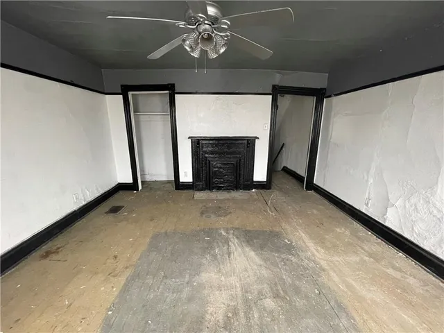 a view of an empty room with a fireplace