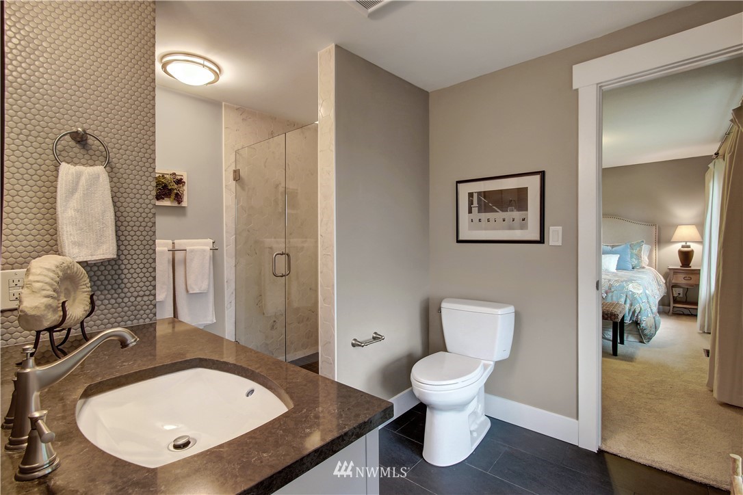 8604 Talbot Road Edmonds, WA 98026 - Photo 16 of 34 a bathroom with a toilet a sink and mirror