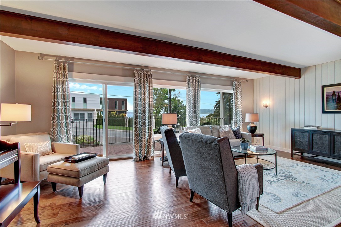 8604 Talbot Road Edmonds, WA 98026 - Photo 6 of 34 a living room with furniture a lamp and a floor to ceiling window
