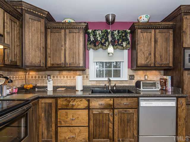 4605 Inwood Road Raleigh, NC 27603 - Photo 6 of 19 Stanless smooth top range and custom tile backsplash!