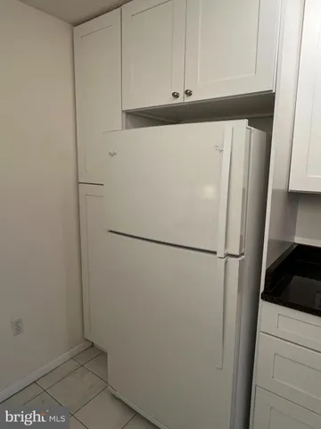 a white refrigerator freezer sitting in a kitchen