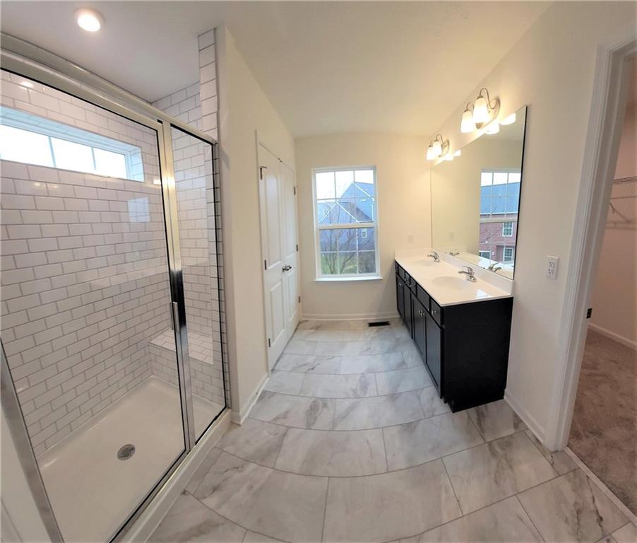 236 Wyncrest Drive Butler, PA 16001 - Photo 13 of 23 a bathroom with a mirror a sink and glass door