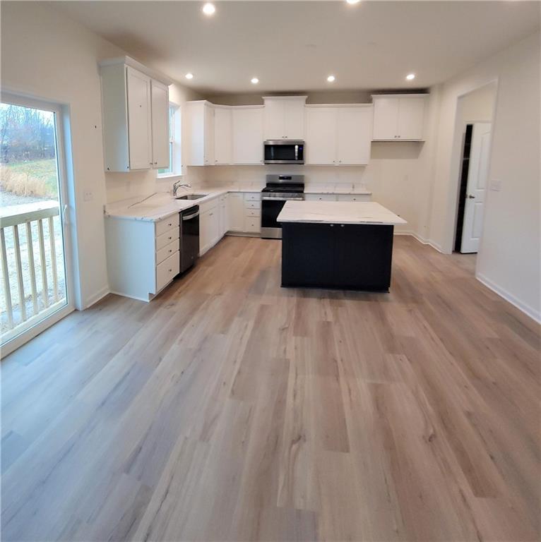 236 Wyncrest Drive Butler, PA 16001 - Photo 7 of 23 a large kitchen with stainless steel appliances a large counter top a wooden floors and a large window
