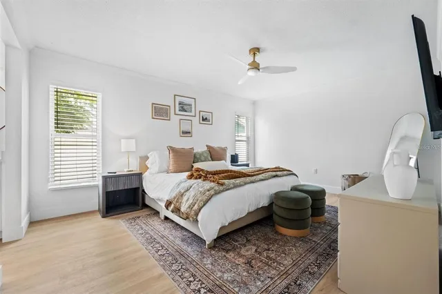 a bedroom with a bed and wooden floor