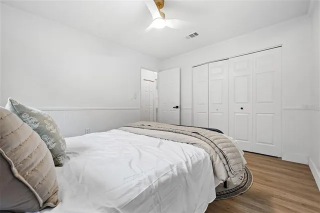 a bedroom with a bed and a painting on the wall