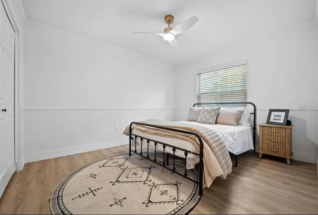 a bedroom with a bed and a chandelier