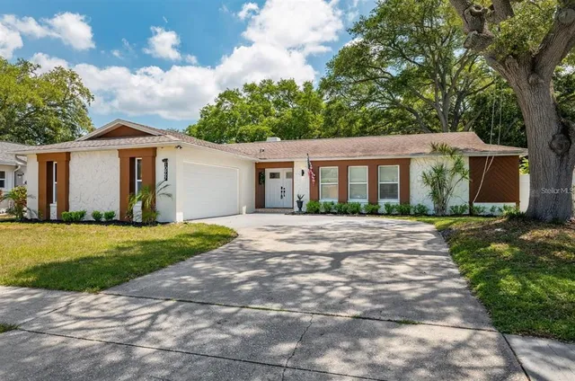 a view of a house with yard and a garden