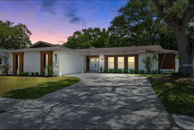 a view of a house with yard and a garden
