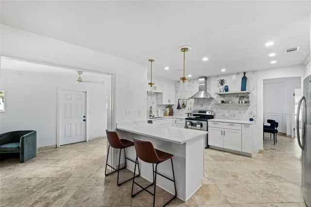 a kitchen with a sink cabinets and stainless steel appliances