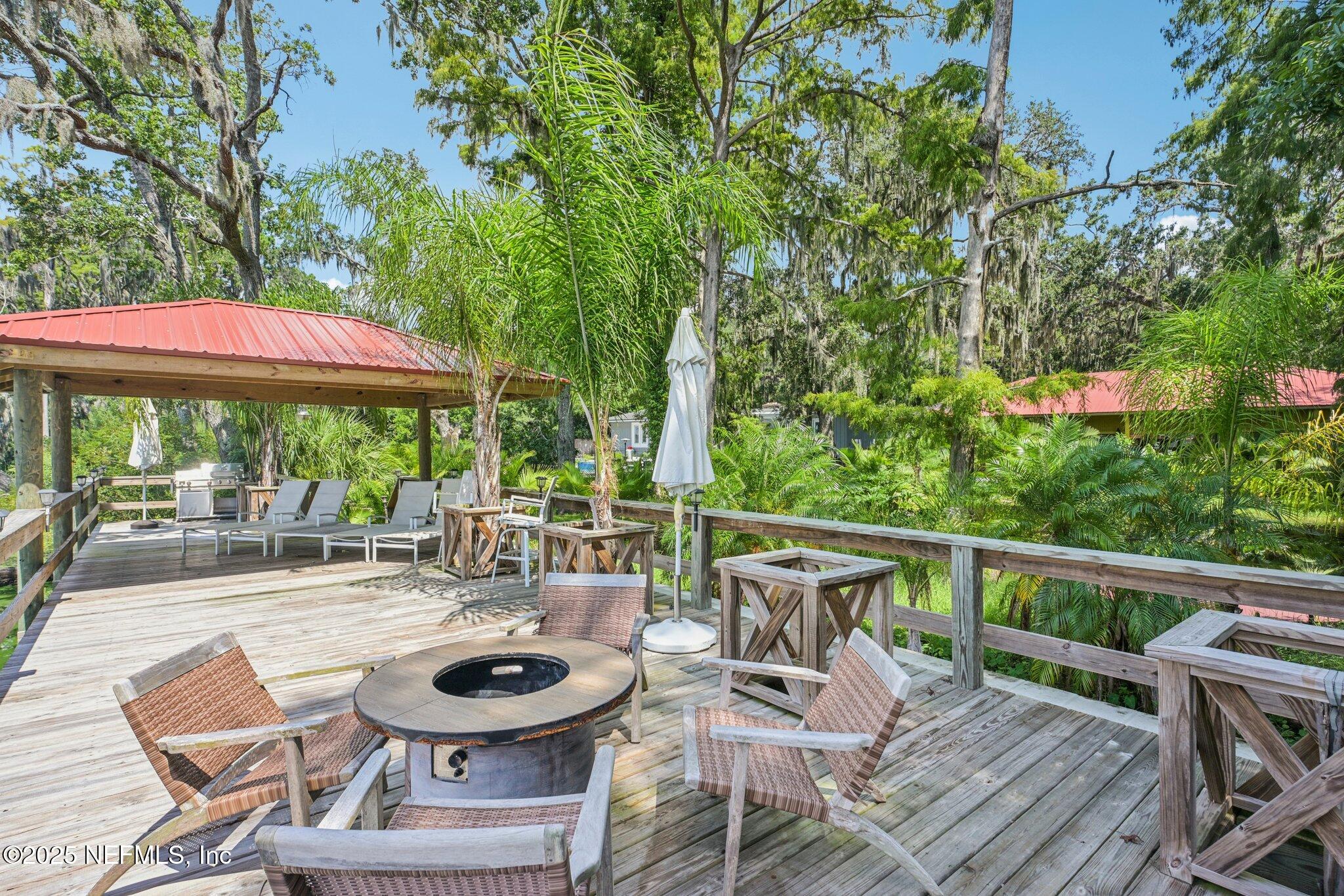 2778 Holly Point Road West Orange Park, FL 32073 - Photo 14 of 68 a patio with a yard table and chairs